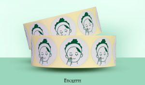 Plain Round Label witha simple illustration of a woman applying a beauty product